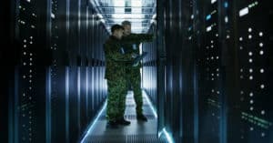 Two army men working on Computer server racks